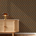 May include: A cabinet with a light-colored woven cane front and a rounded side, topped with a dome-shaped glass lamp. The wall behind features a repeating geometric pattern of vertical gold-colored ovals linked by small circles on a dark background.